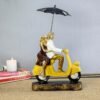 Romantic Couple Riding Yellow Scooter Statue - A Symbol of Love and Adventure